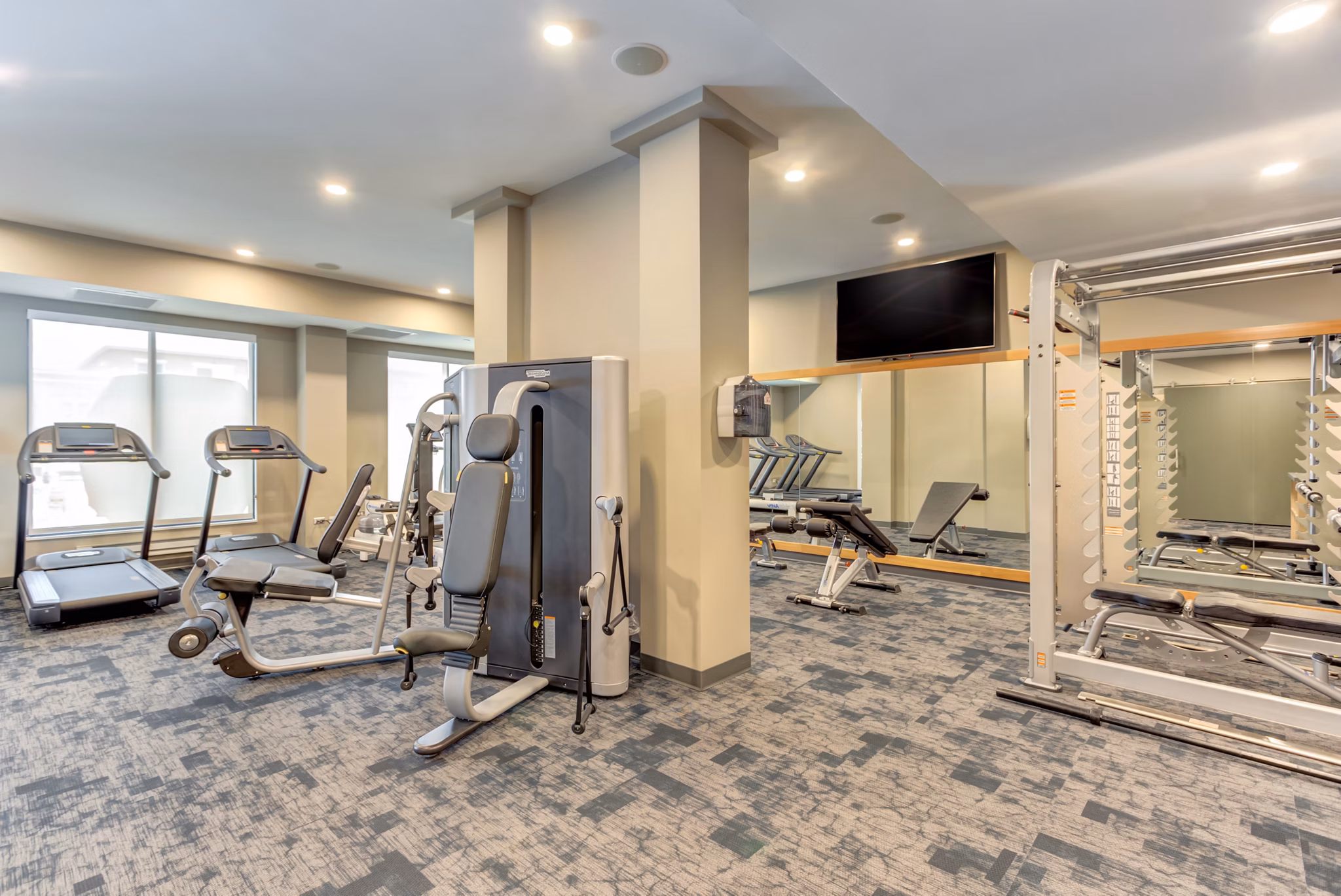 Modern fitness center with state-of-the-art equipment at The Marke of Elmhurst Apartments, perfect for maintaining a healthy lifestyle