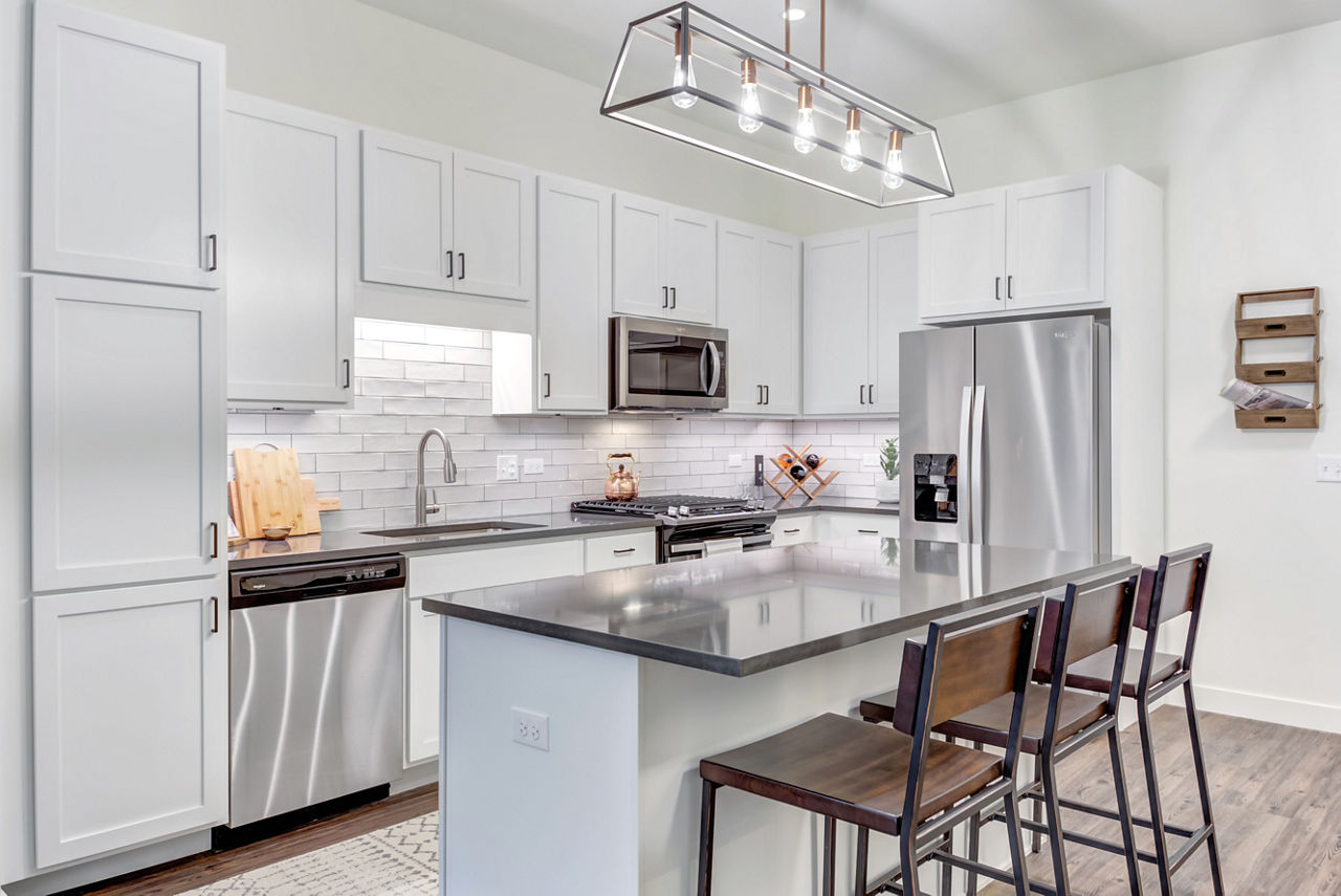 Modern kitchen with stainless steel appliances at The Marke of Elmhurst Apartments