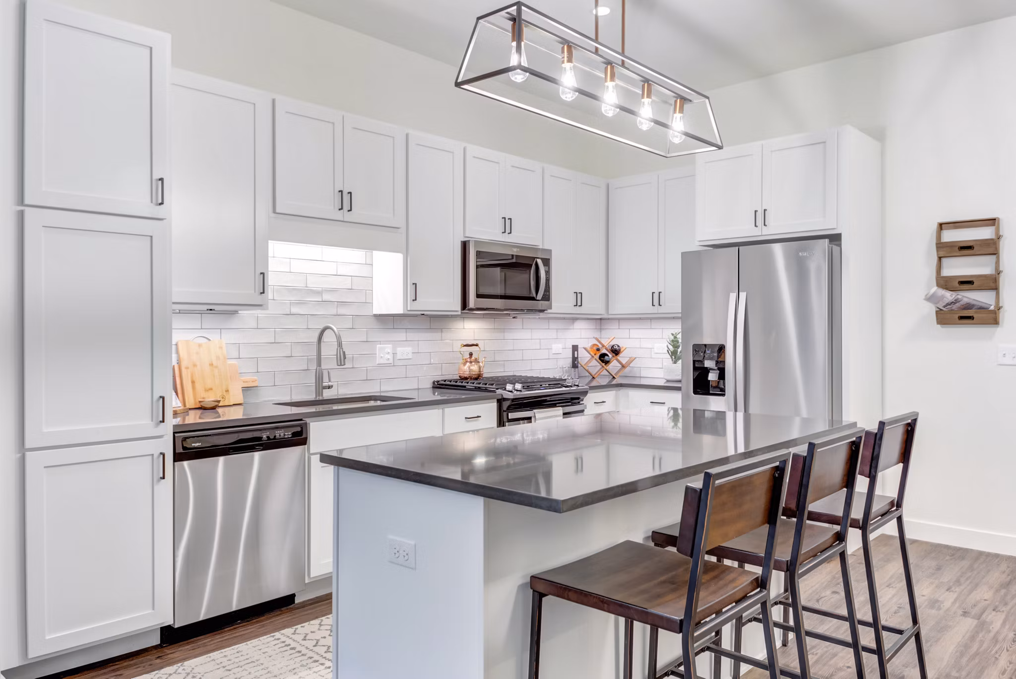 Modern kitchen with stainless steel appliances at The Marke of Elmhurst Apartments