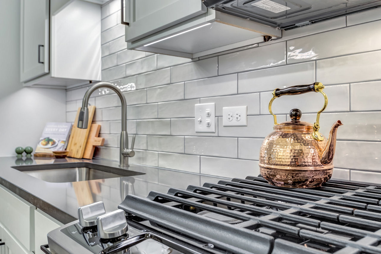 Modern kitchen with sleek countertops and stainless steel appliances at The Marke of Elmhurst Apartments
