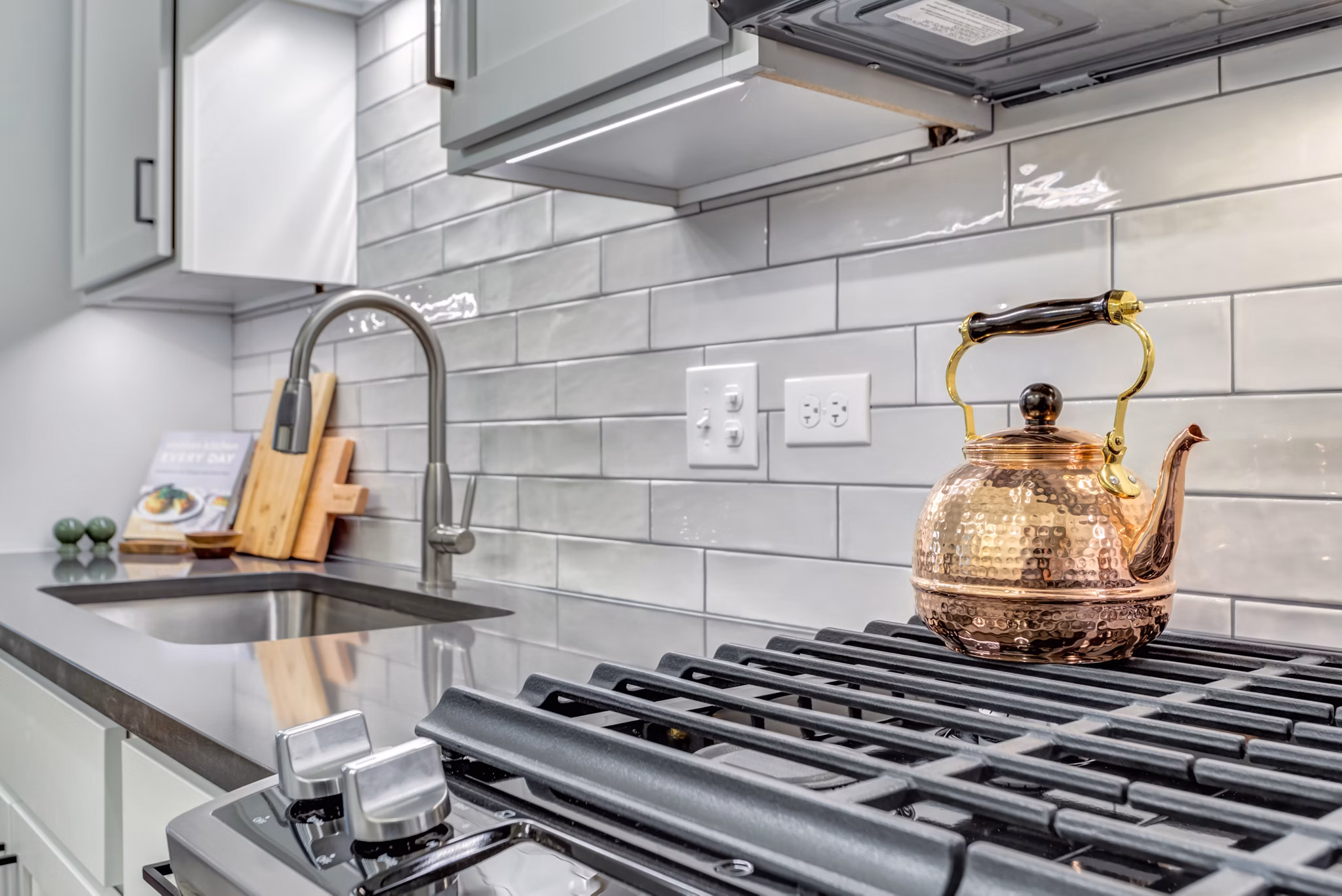 Modern kitchen with sleek countertops and stainless steel appliances at The Marke of Elmhurst Apartments
