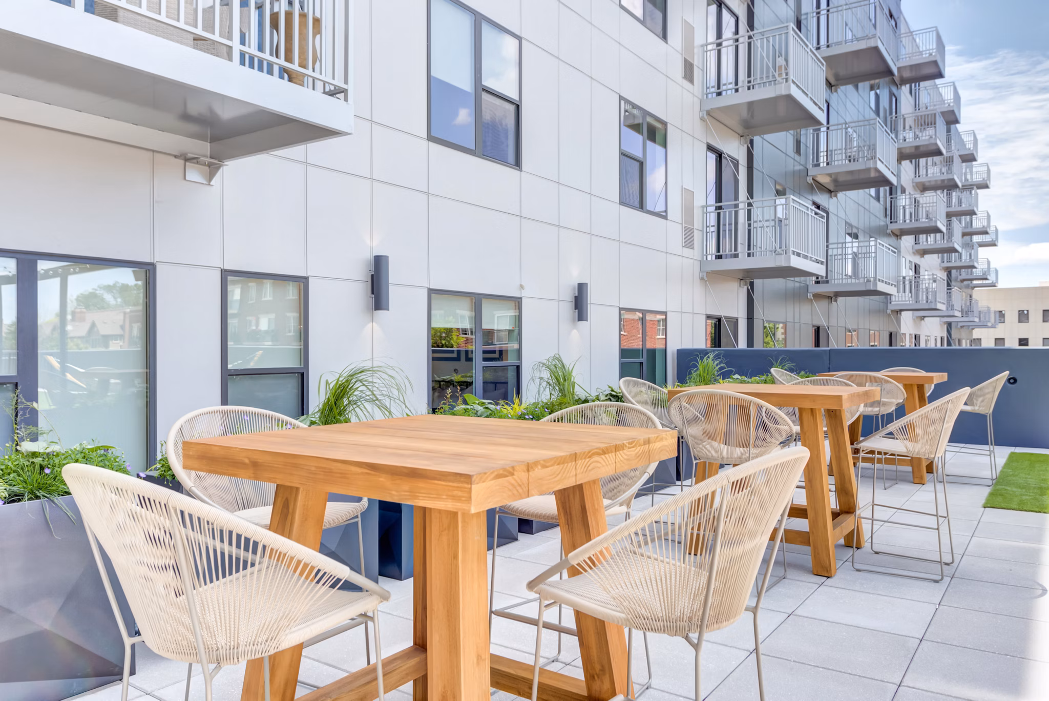 Courtyard with lush gardens and seating at The Marke of Elmhurst Apartments