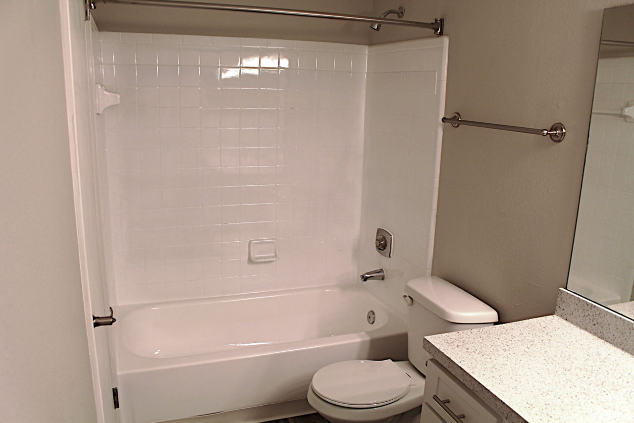 Bathroom with modern fixtures and sleek design at Island Club Apartments
