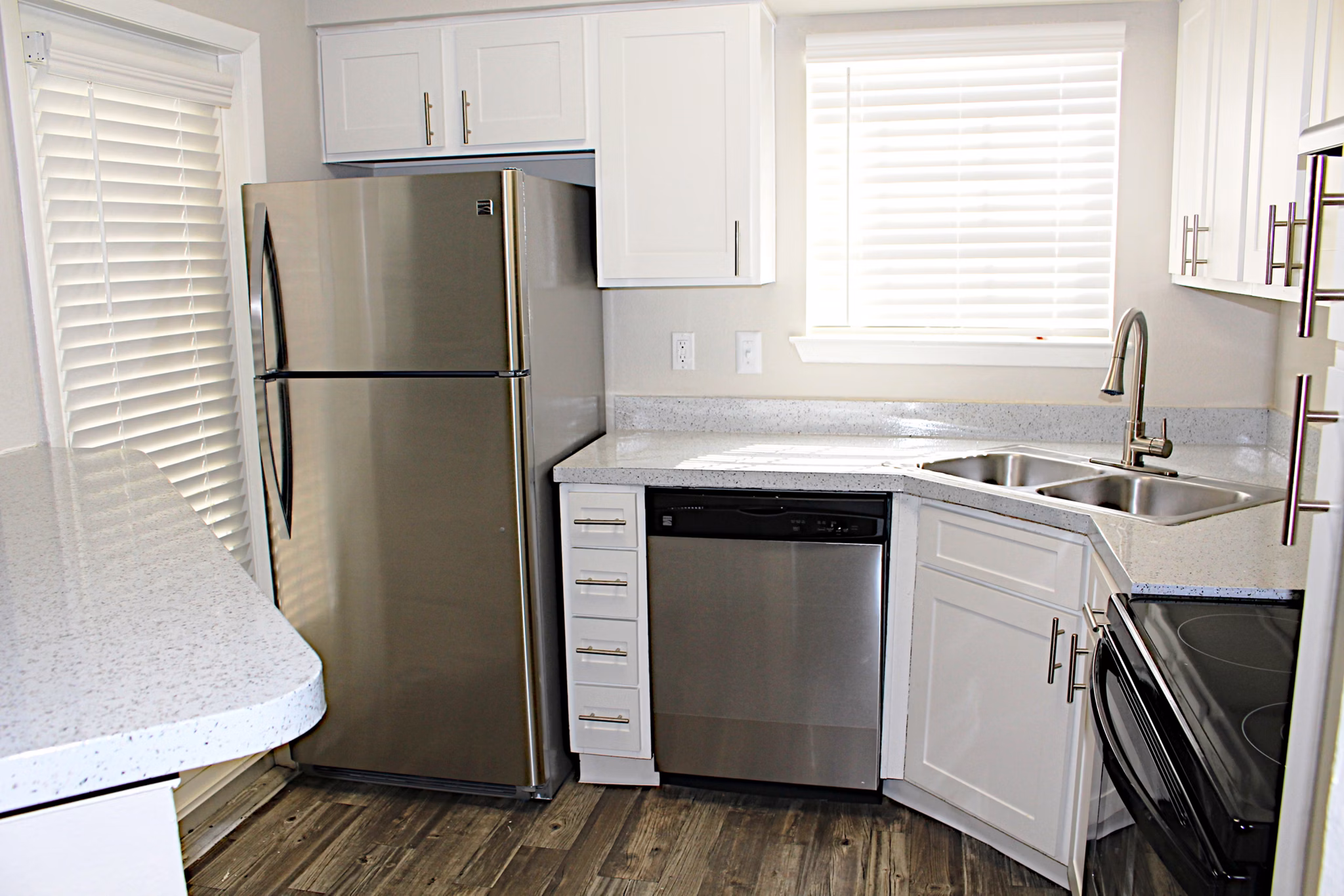 Modern kitchen with stainless steel appliances in Island Club Apartments