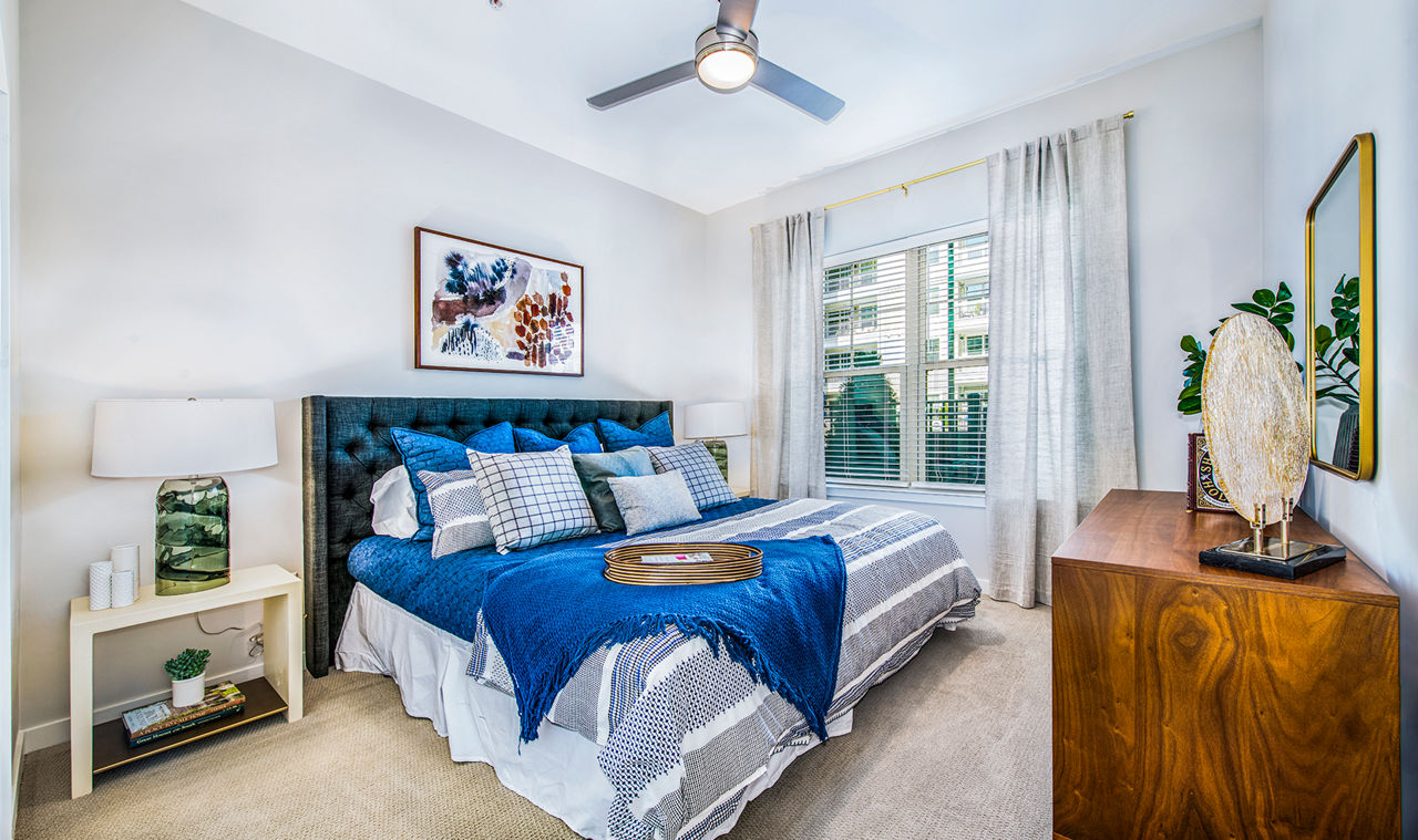 Cozy bedroom with modern decor at Overture Greenville Apartments, a Greystar property in Greenville