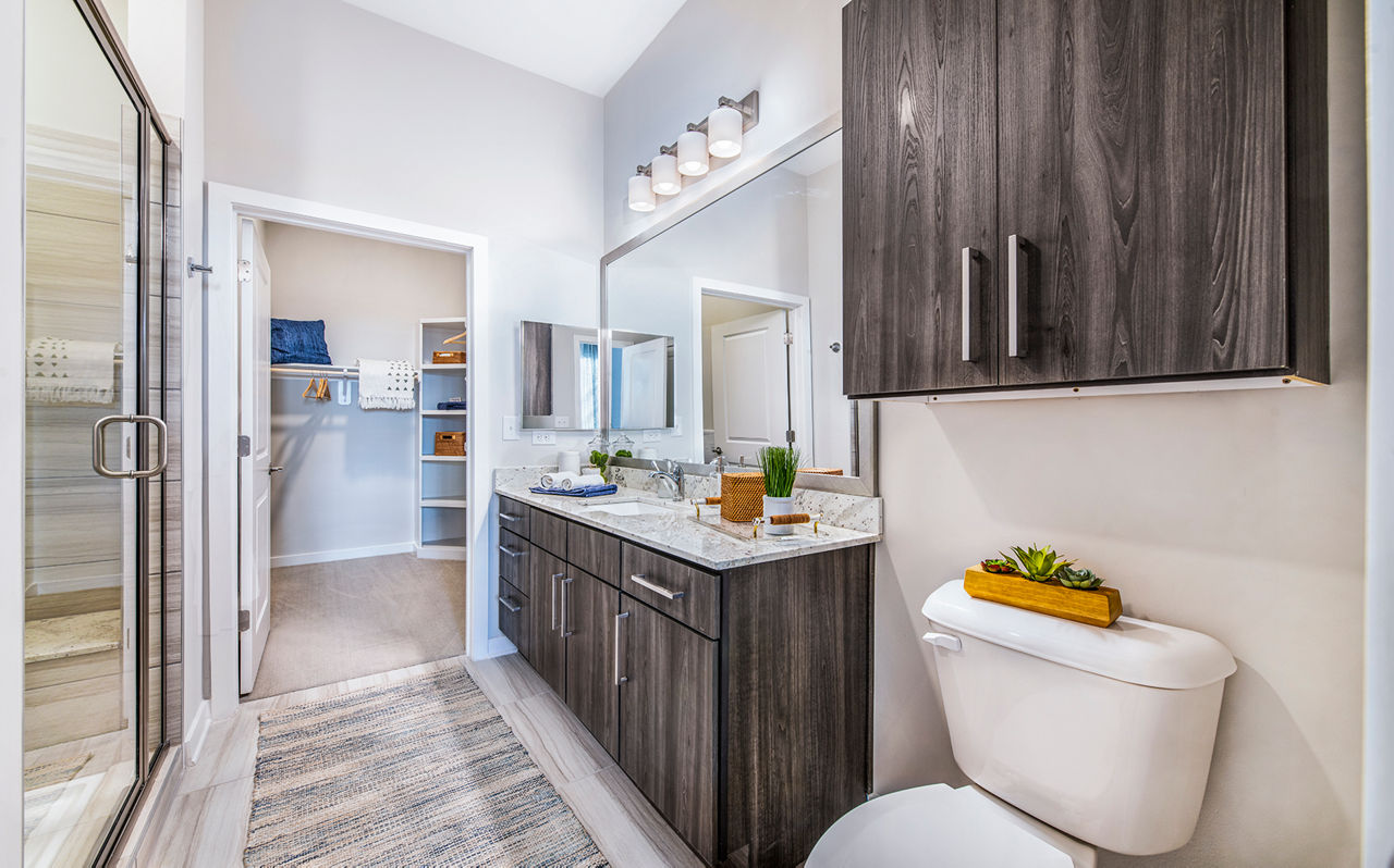 Luxurious bathroom featuring sleek fixtures and marble countertops at Overture Greenville Apartments, catering to upscale living