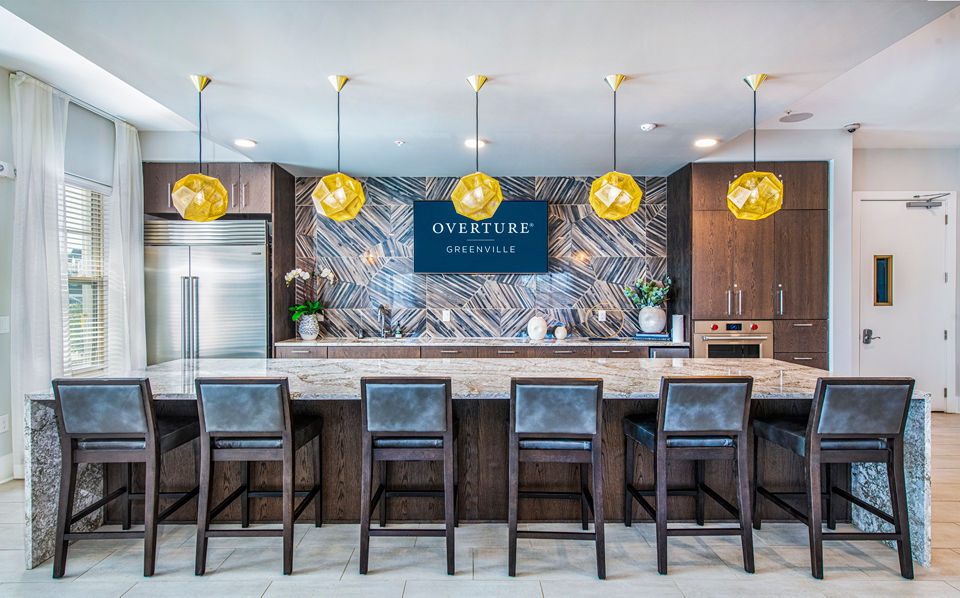 Clubhouse kitchen featuring modern appliances and sleek countertops at Overture Greenville Apartments, a luxury living community