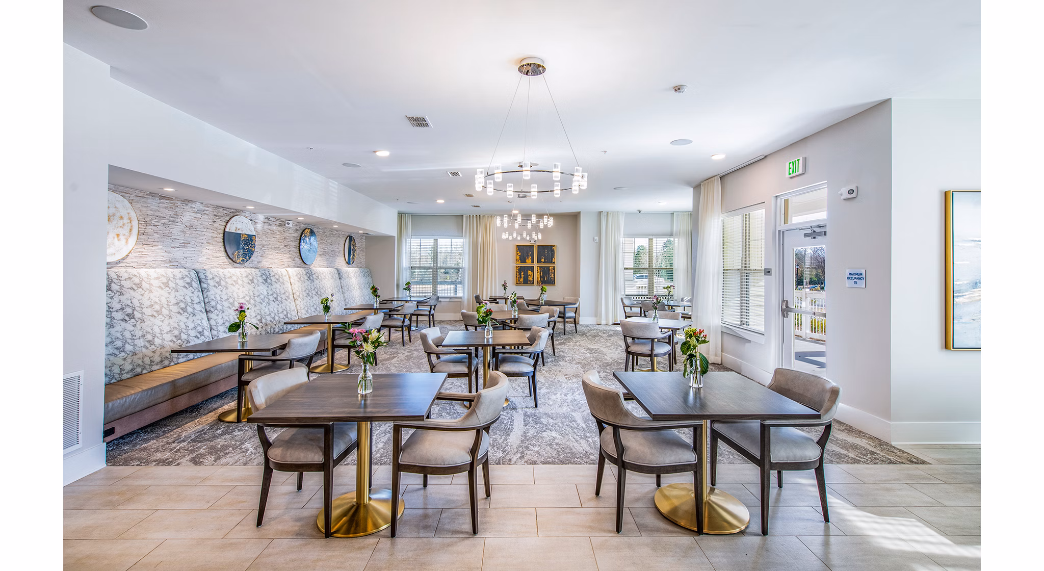 Overture Greenville Apartments: Elegant clubhouse dining room with cozy seating and modern decor, perfect for social gatherings and dining events