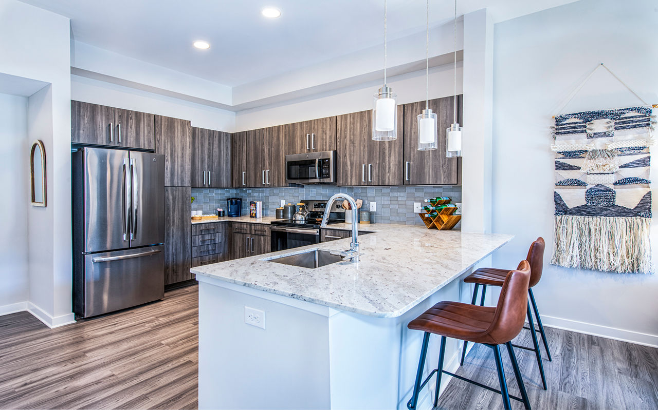 Modern kitchen with stainless steel appliances in Overture Greenville Apartments