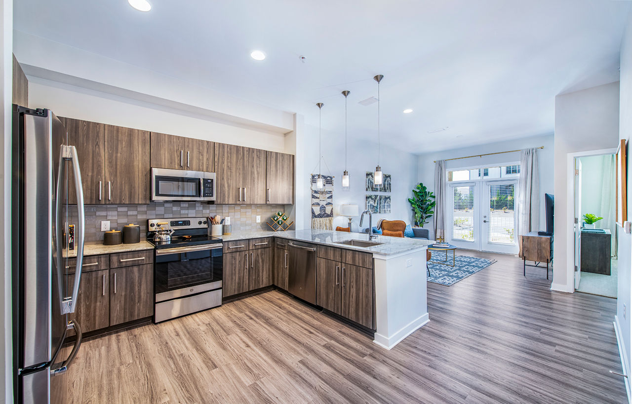 Modern kitchen with stainless steel appliances in Overture Greenville Apartments