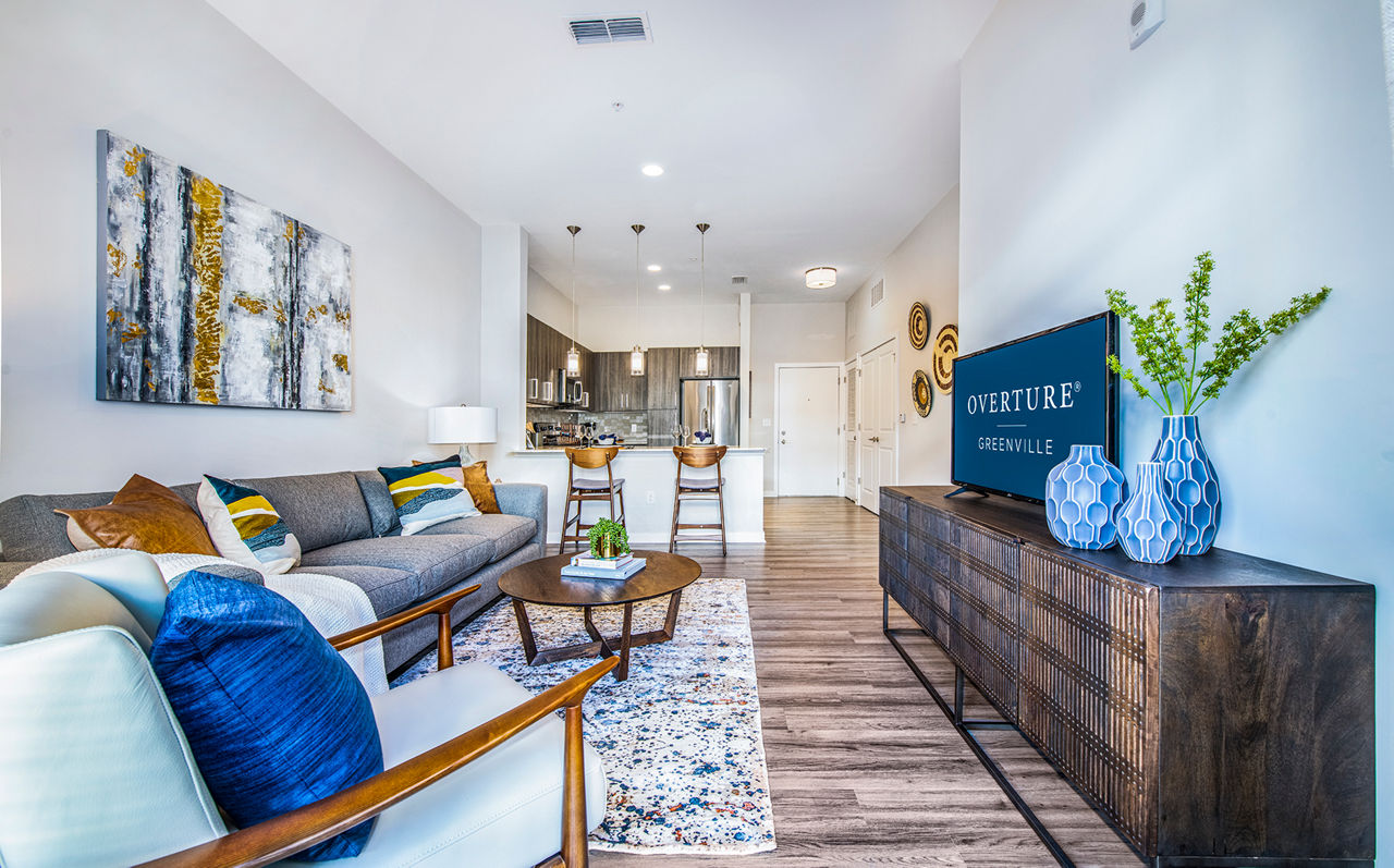 Spacious living room featuring modern decor and ample natural light at Overture Greenville Apartments