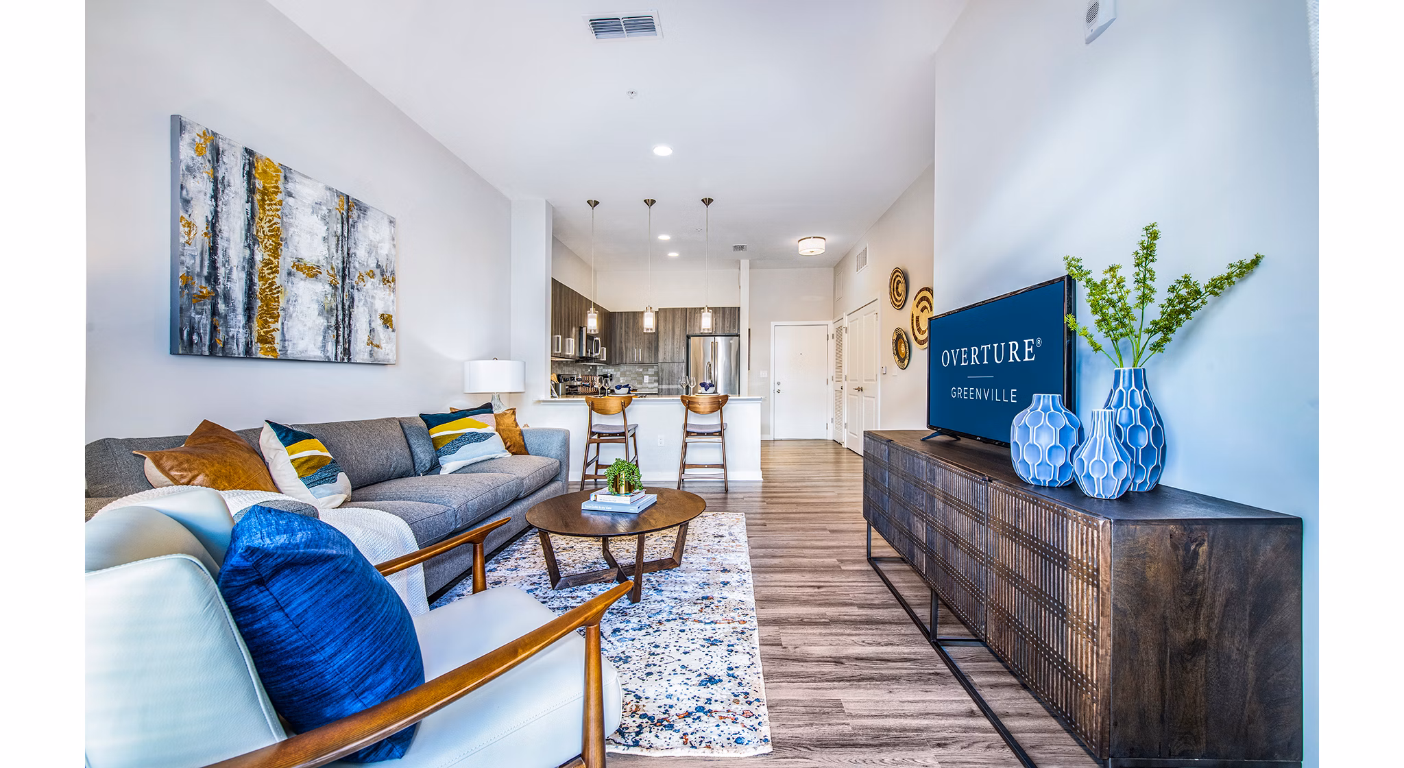 Spacious living room featuring modern decor and ample natural light at Overture Greenville Apartments