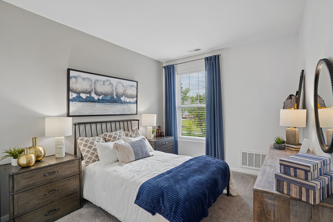 Cozy bedroom with modern furnishings at Highland Ridge Apartments