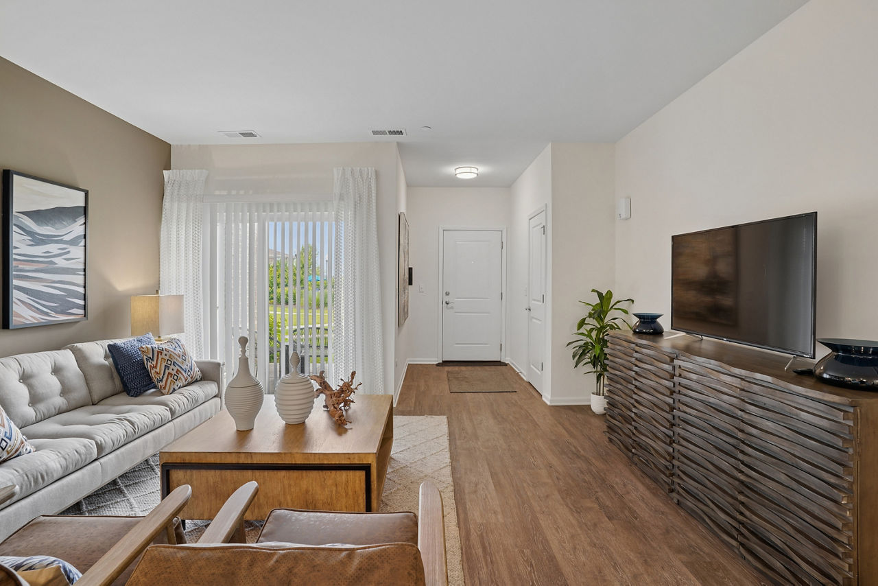 Chic living room with modern decor and ample natural light in Highland Ridge Apartments