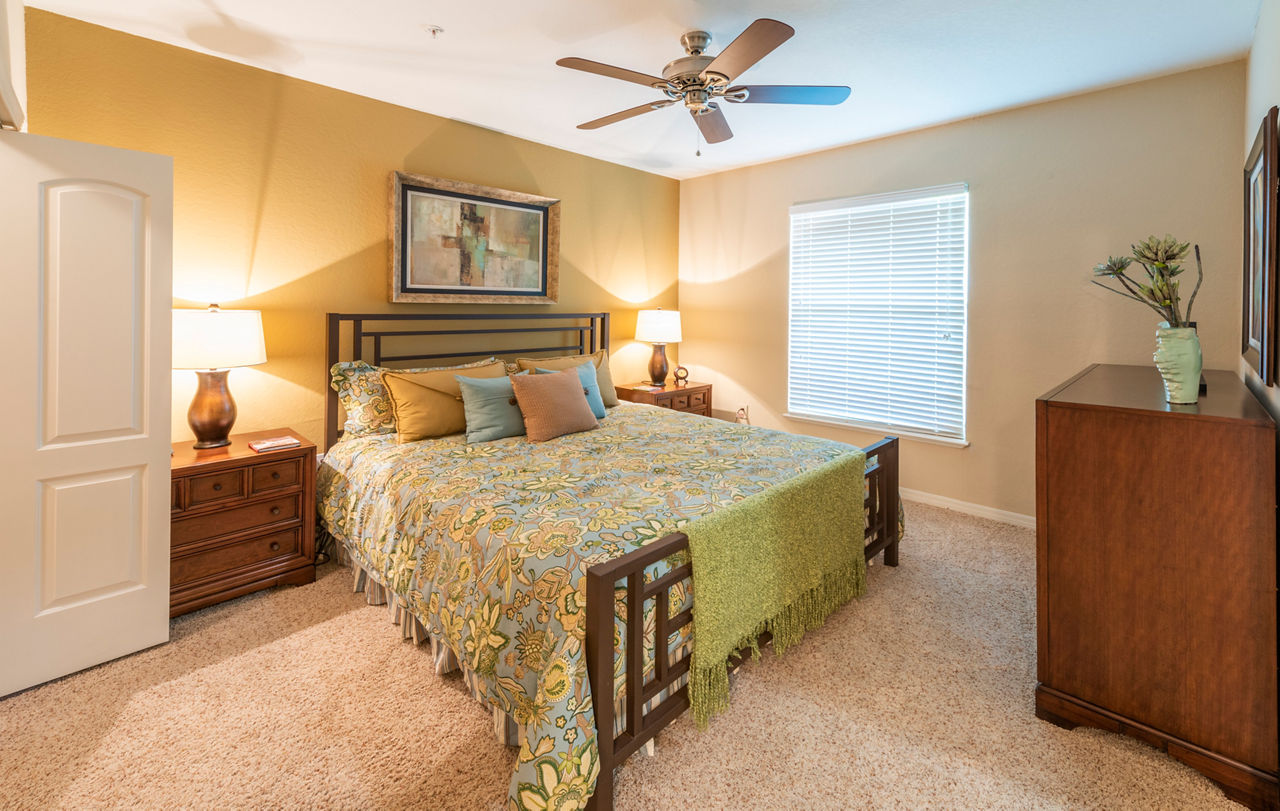 Boutique bedroom featuring elegant decor and coastal views at Legacy On The Bay Apartments