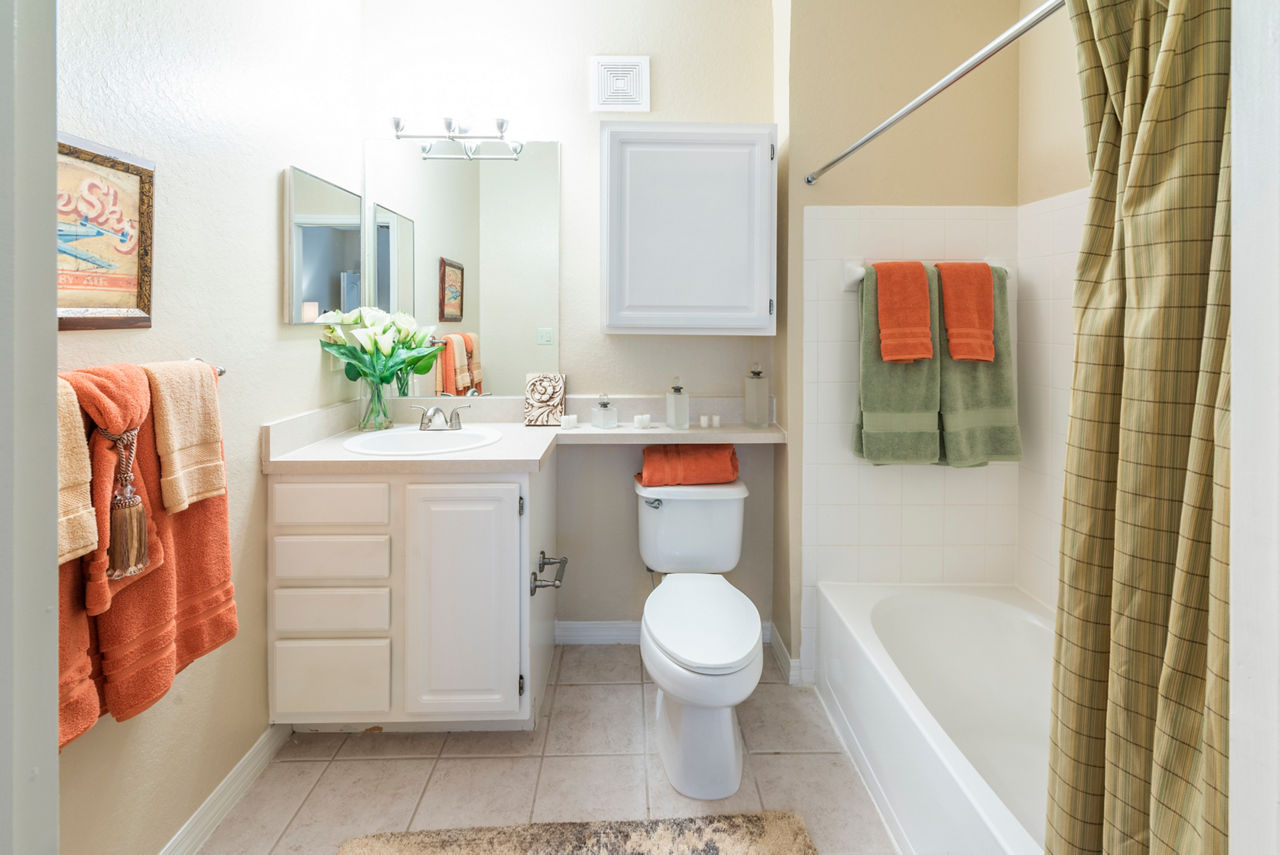 Elegant bathroom with marble countertops and soaking tub at Legacy On The Bay Apartments