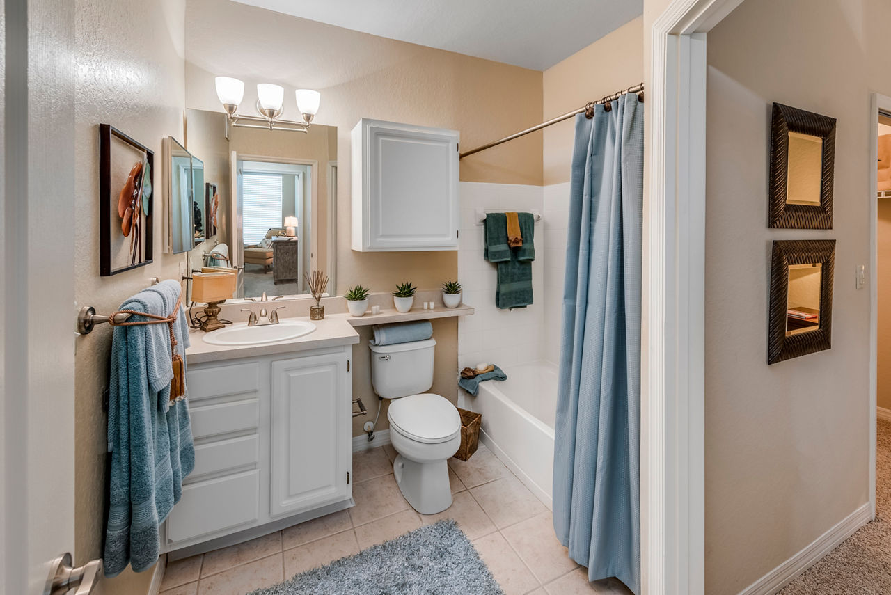 Modern bathroom with granite countertops at Legacy On The Bay Apartments