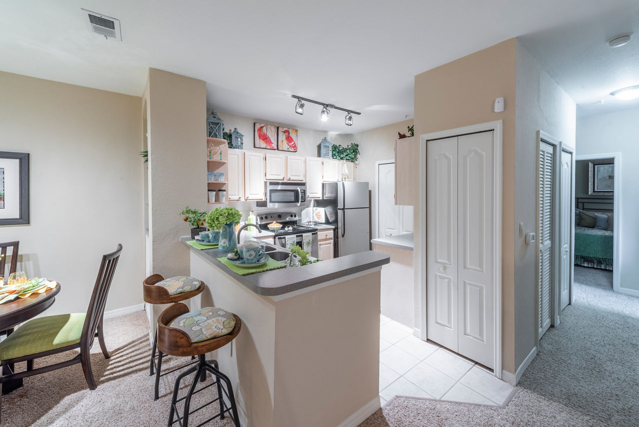 Modern kitchen with stainless steel appliances in Legacy On The Bay Apartments
