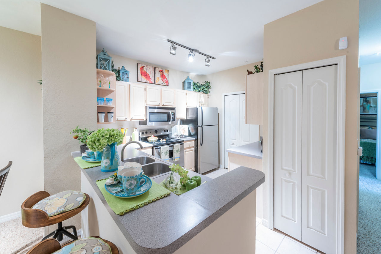 Modern kitchen with stainless steel appliances at Legacy On The Bay Apartments