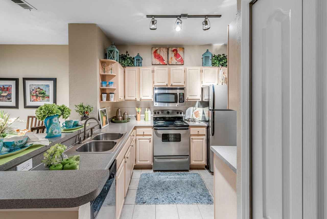 Modern kitchen featuring stainless steel appliances in Legacy On The Bay Apartments