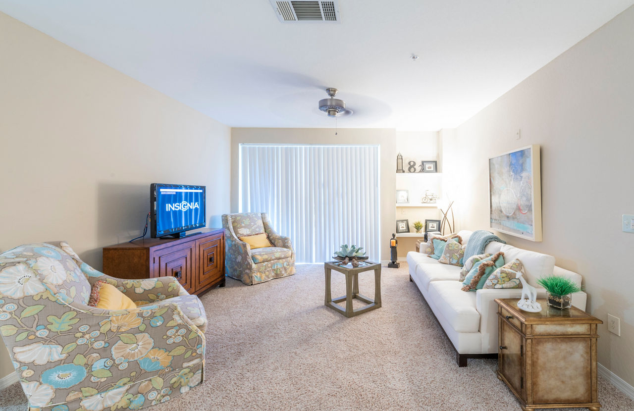 Modern living room with elegant furnishings at Legacy On The Bay Apartments, perfect for relaxation and entertainment in a luxurious setting