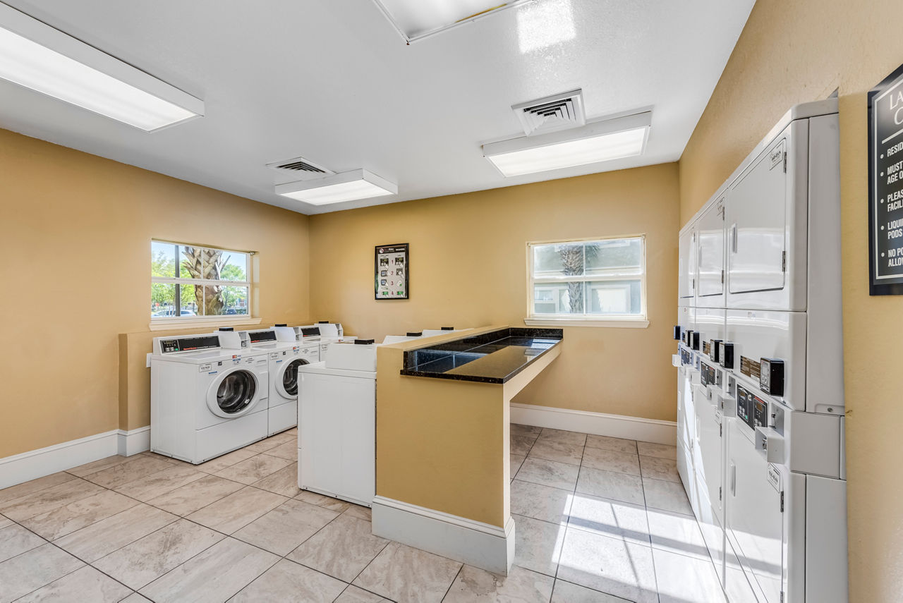 Laundry facility in Legacy On The Bay Apartments offering modern washers and dryers for resident convenience