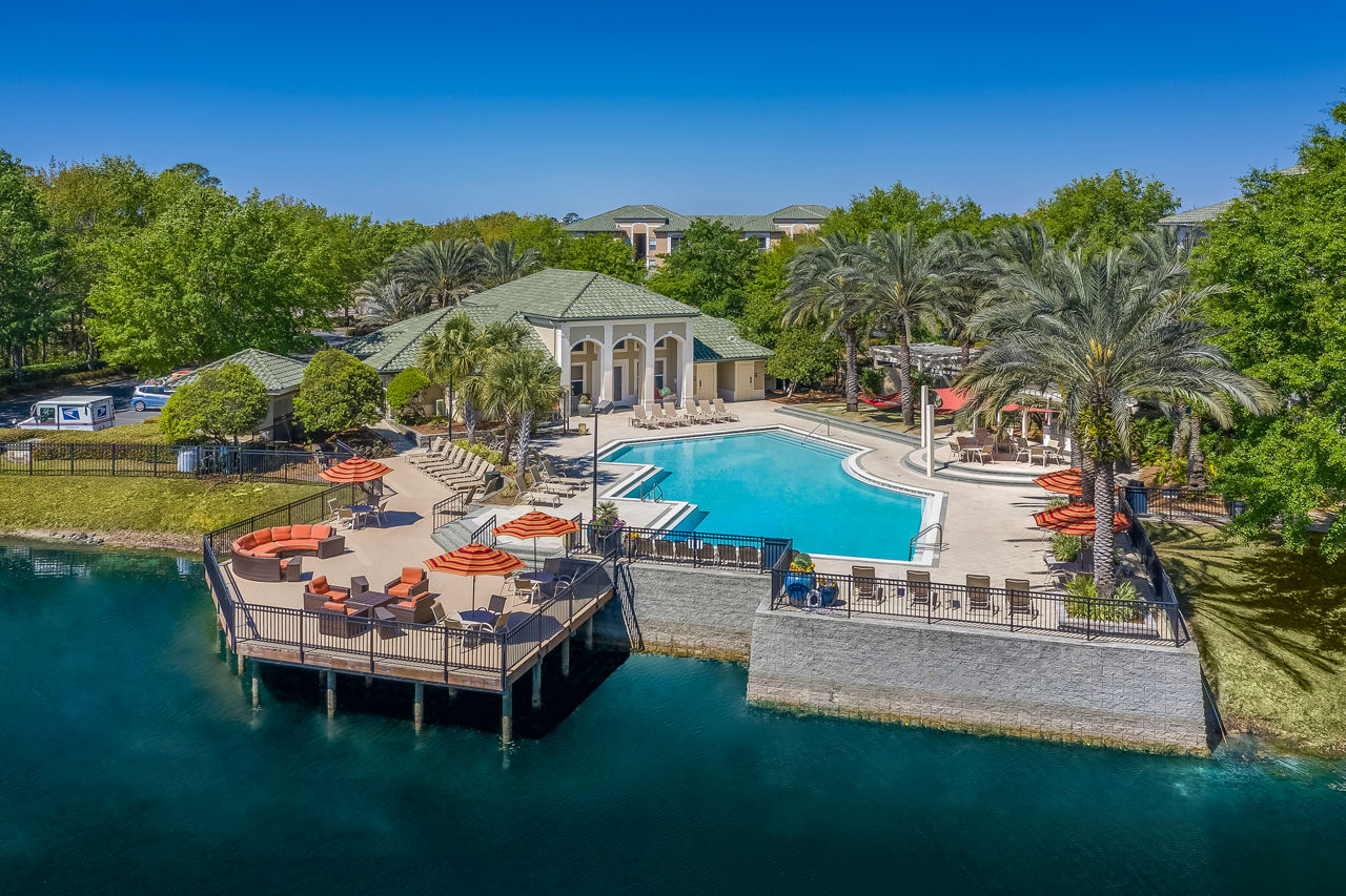 Relaxing pool with sundeck at Legacy On The Bay Apartments