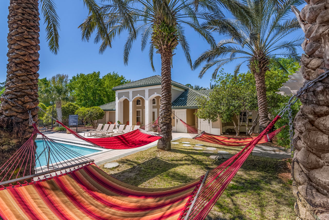 Tranquil courtyard with lush greenery at Legacy On The Bay Apartments