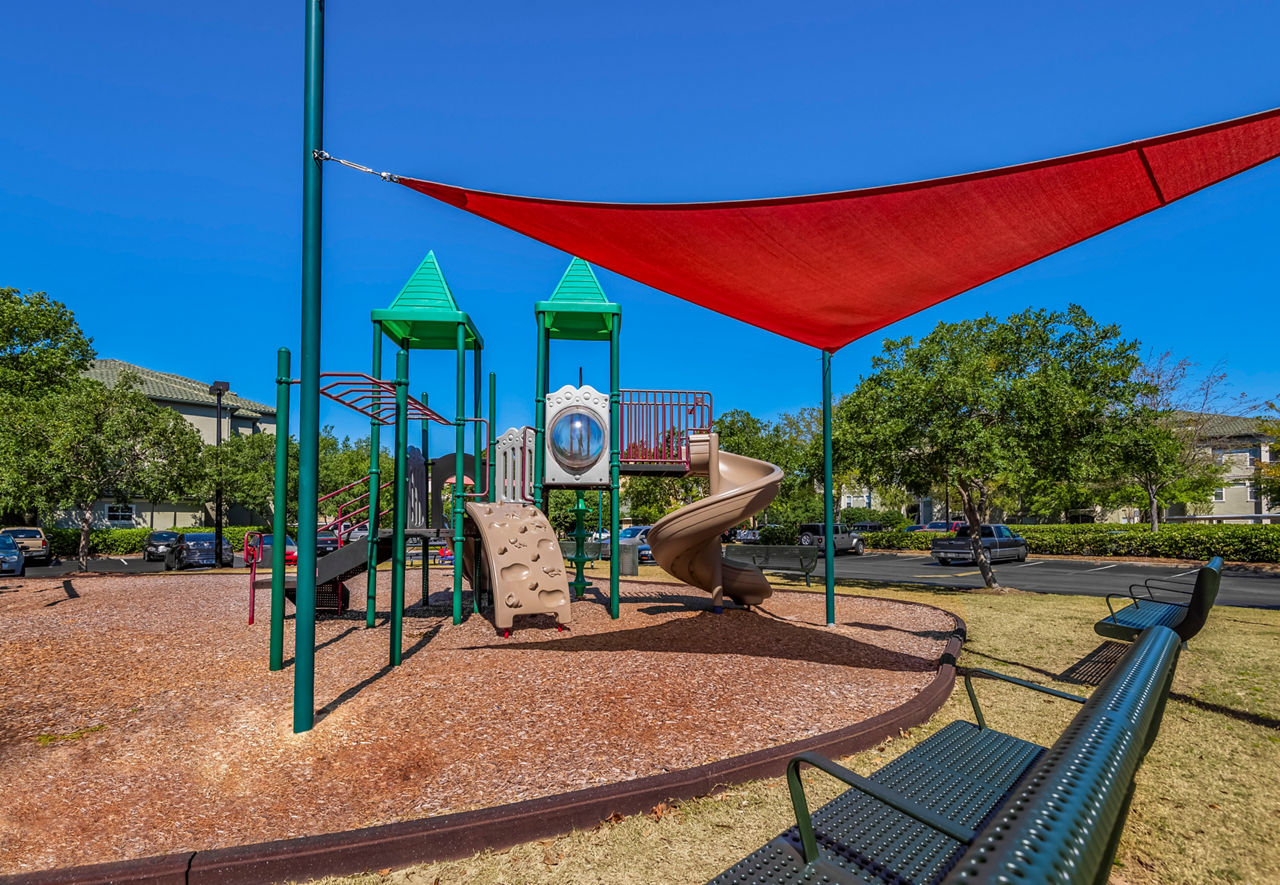 Playful children's playground at Legacy On The Bay Apartments in Destin, offering family-friendly amenities for residents