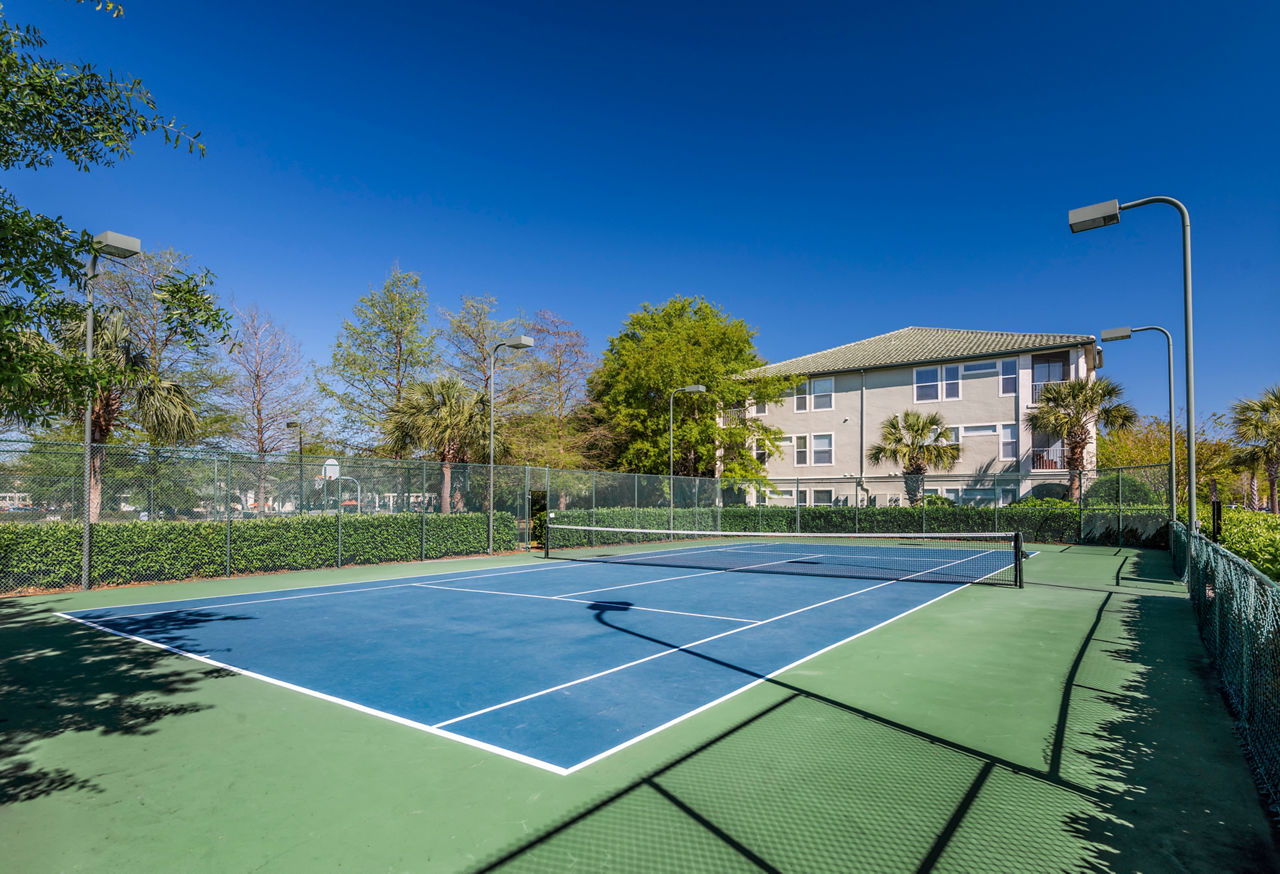 Sport court for basketball and tennis at Legacy On The Bay Apartments, featuring well-maintained surfaces for recreational activities