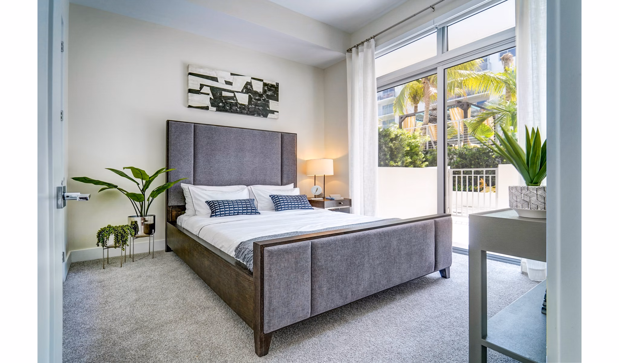 Cozy bedroom with modern decor at Oversea at Flagler Banyan Square Apartments, luxury living by Greystar