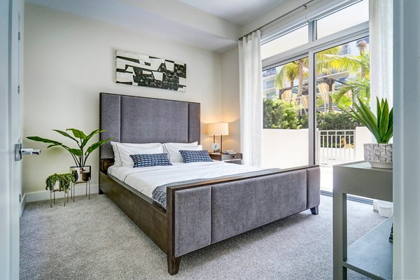 Cozy bedroom with modern decor at Oversea at Flagler Banyan Square Apartments, luxury living by Greystar