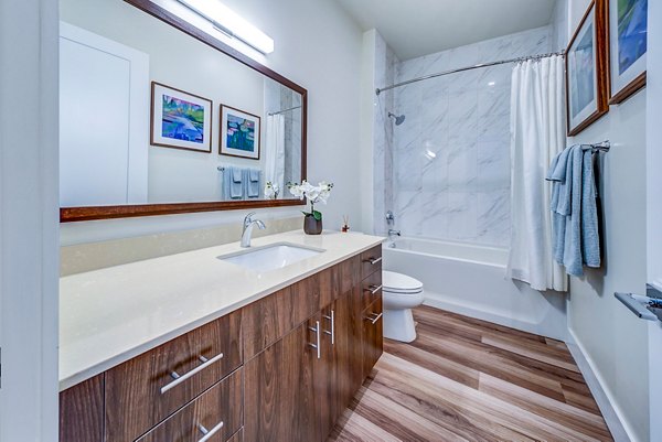 Bathroom with sleek finishes and modern fixtures at Oversea at Flagler Banyan Square luxury apartments