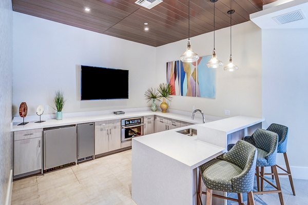Clubhouse featuring modern design and cozy seating at Oversea at Flagler Banyan Square Apartments