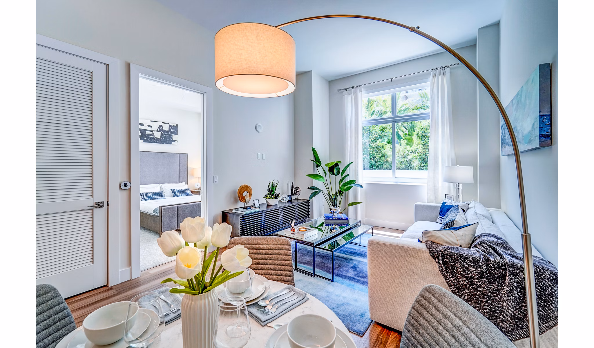 Dining area with sleek furniture and modern lighting at Oversea at Flagler Banyan Square Apartments Elegant space for luxury living experiences