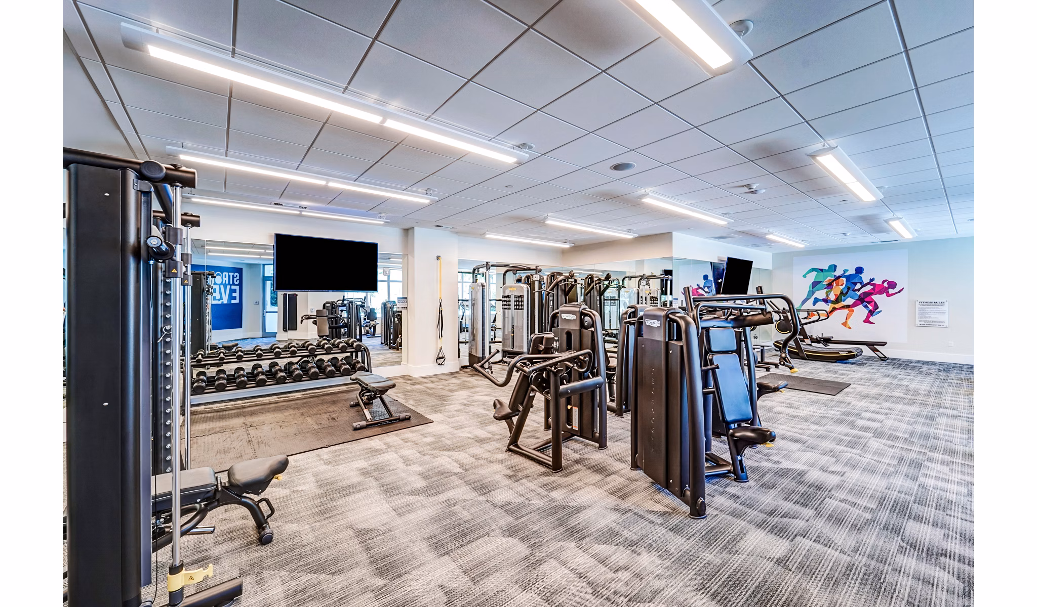 State-of-the-art fitness center at Oversea at Flagler Banyan Square luxury apartments with modern equipment and spacious workout areas