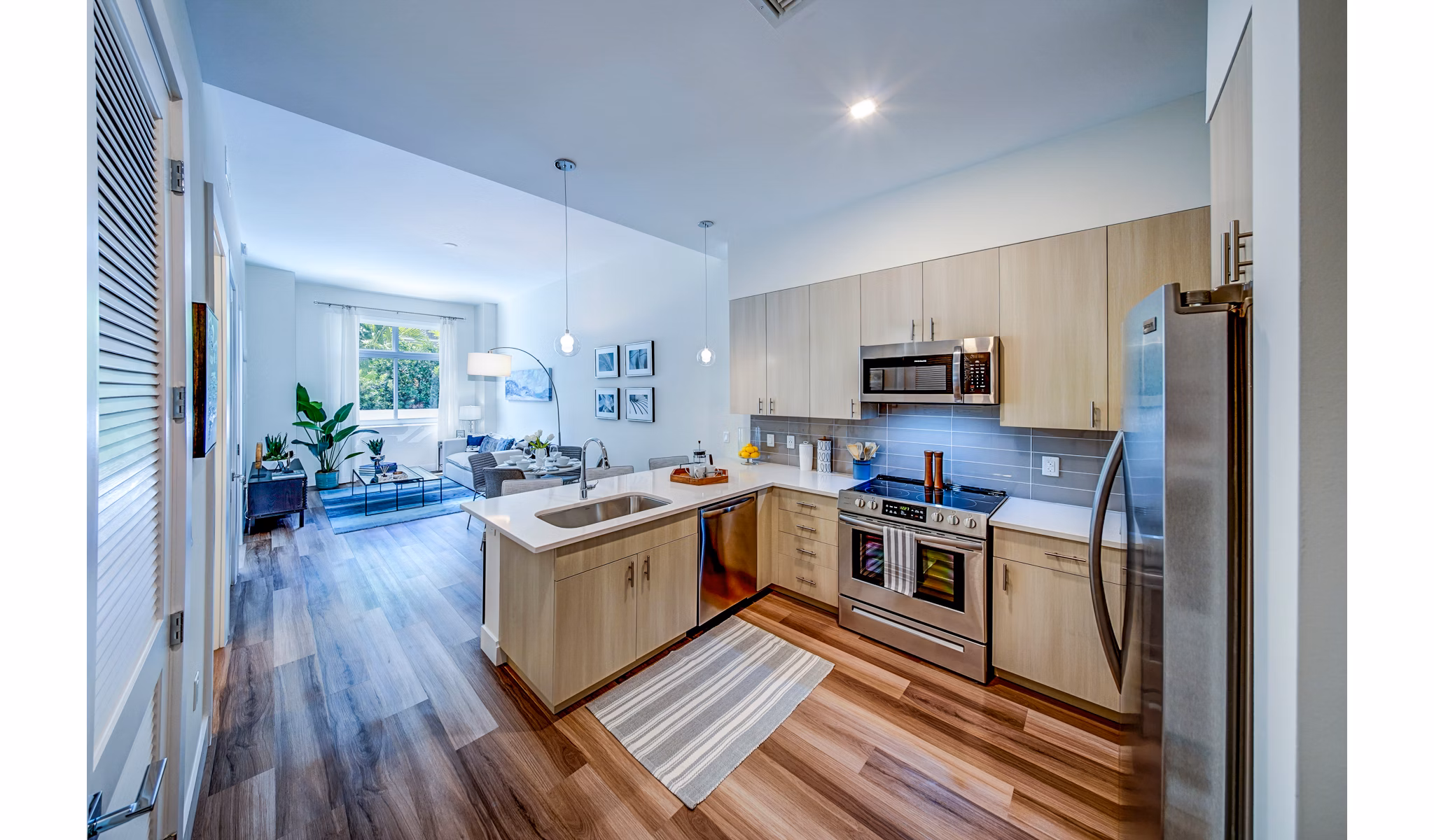 Modern kitchen with stainless steel appliances at Oversea at Flagler Banyan Square apartments