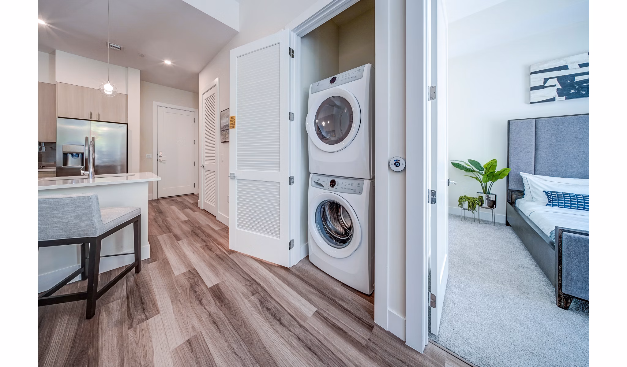 Laundry room featuring modern washers and dryers at Oversea at Flagler Banyan Square Apartments