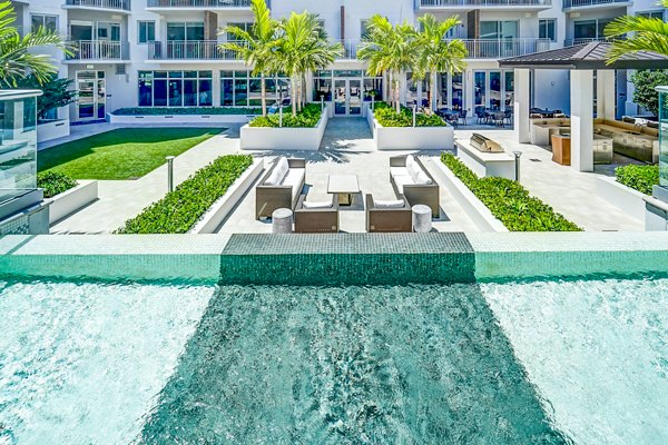 Courtyard with lush greenery at Oversea at Flagler Banyan Square Apartments