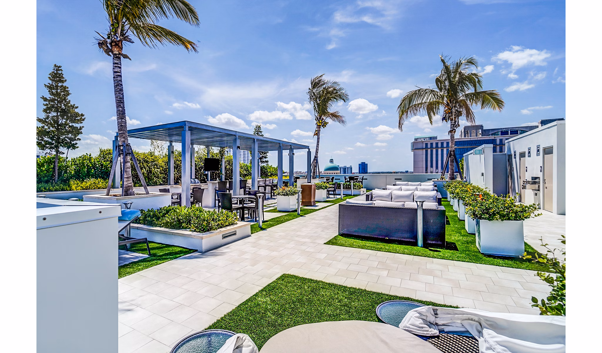Peaceful courtyard with lush greenery at Oversea at Flagler Banyan Square Apartments