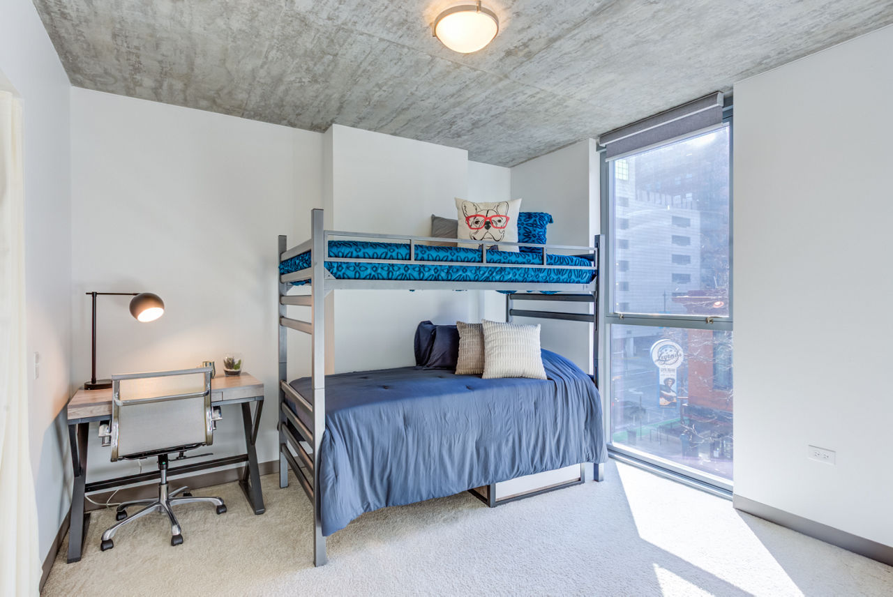 Modern bedroom with large windows and stylish decor in Greystar luxury apartments