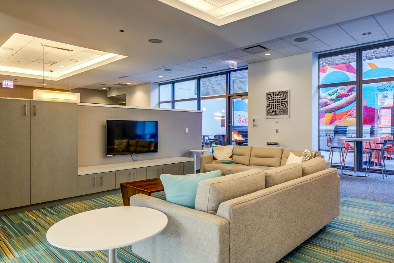 Hallway with mailboxes and digital welcome screens at luxury apartments