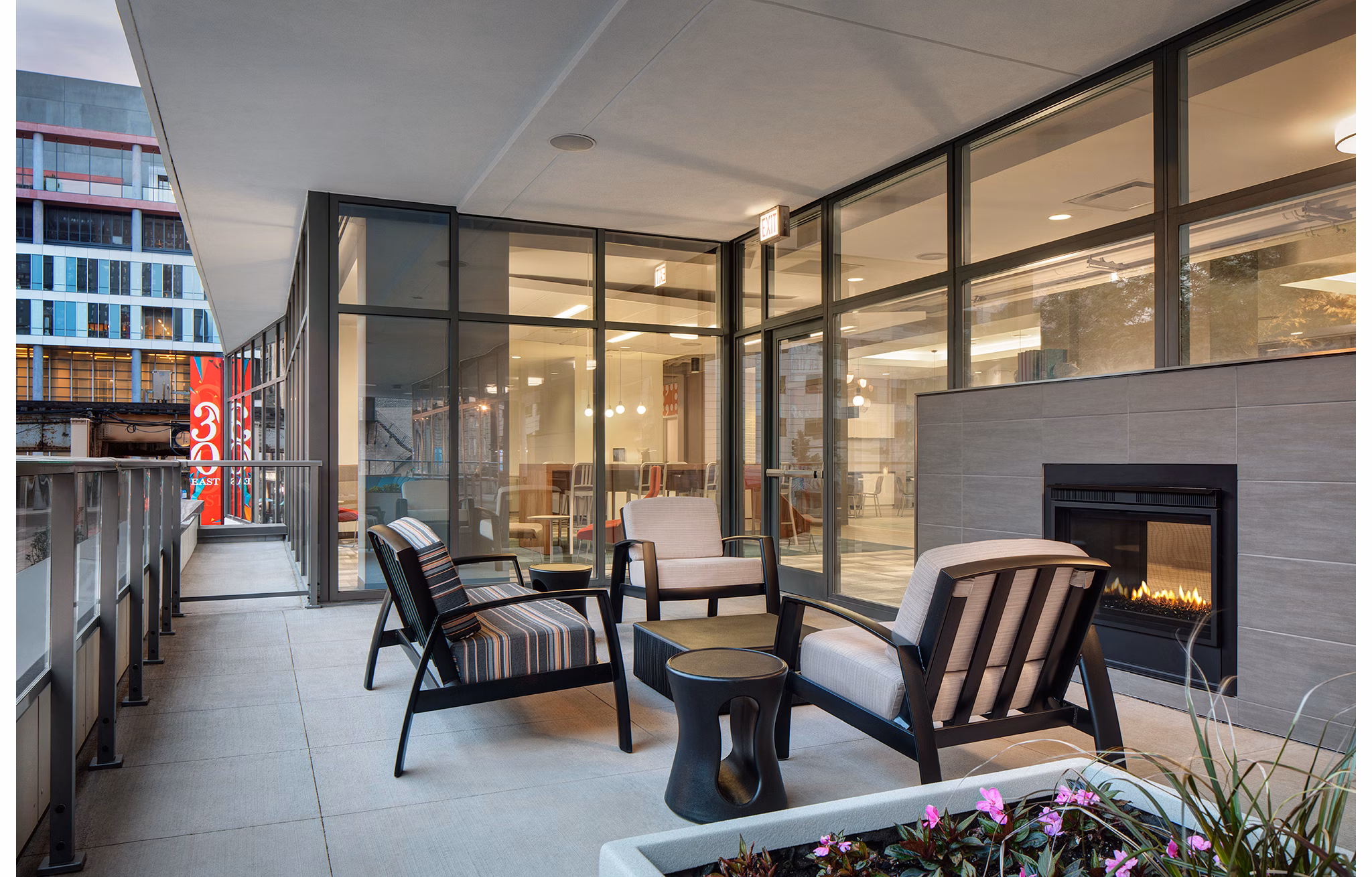 Modern outdoor patio with seating and a cozy fireplace at luxury apartments