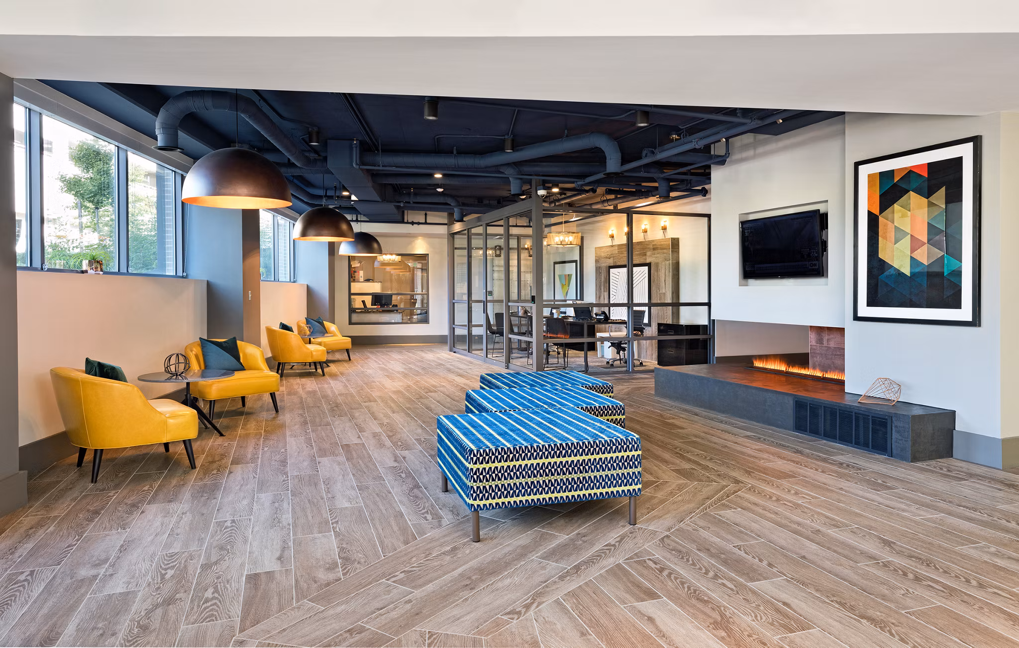 Modern clubhouse featuring communal seating and entertainment areas at Flats at 703 Apartments