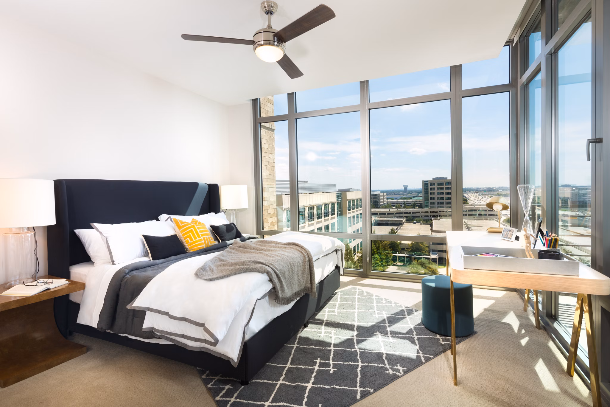 Cozy bedroom with modern decor at The Kincaid at Legacy Apartments, featuring plush bedding and ample natural light
