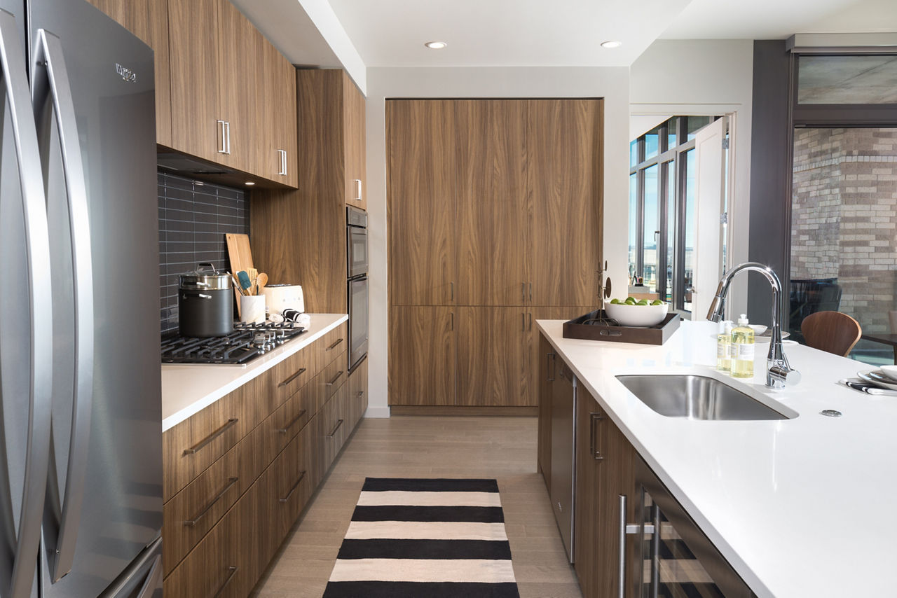 Modern kitchen with stainless steel appliances at The Kincaid at Legacy Apartments