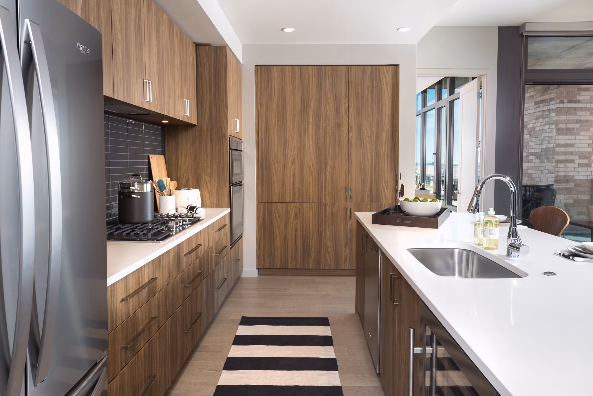 Modern kitchen with stainless steel appliances at The Kincaid at Legacy Apartments