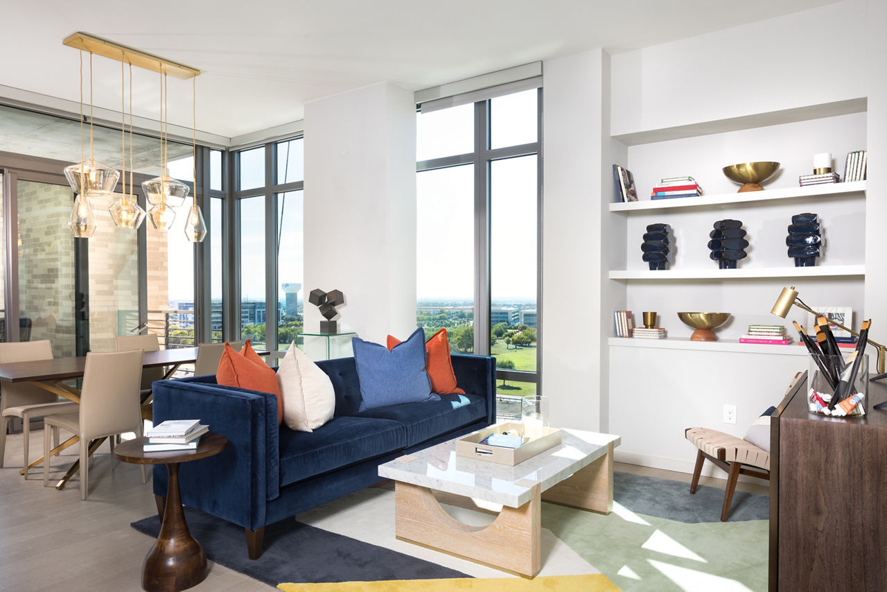 Modern living room with plush seating and city views at The Kincaid at Legacy Apartments