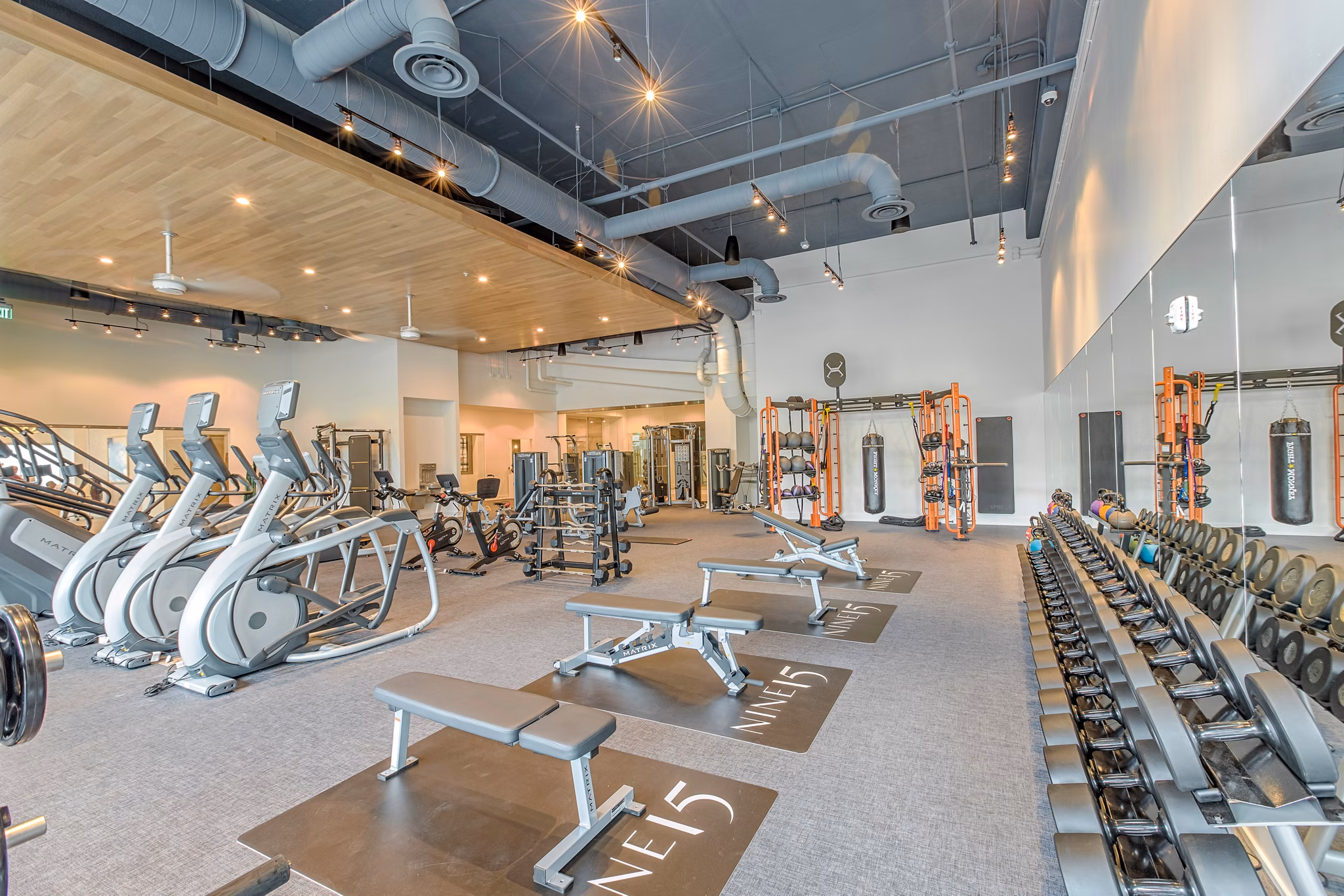 Fitness center with modern equipment at Nine15 Apartments, luxury Greystar property offering upscale amenities and lifestyle in a vibrant urban area