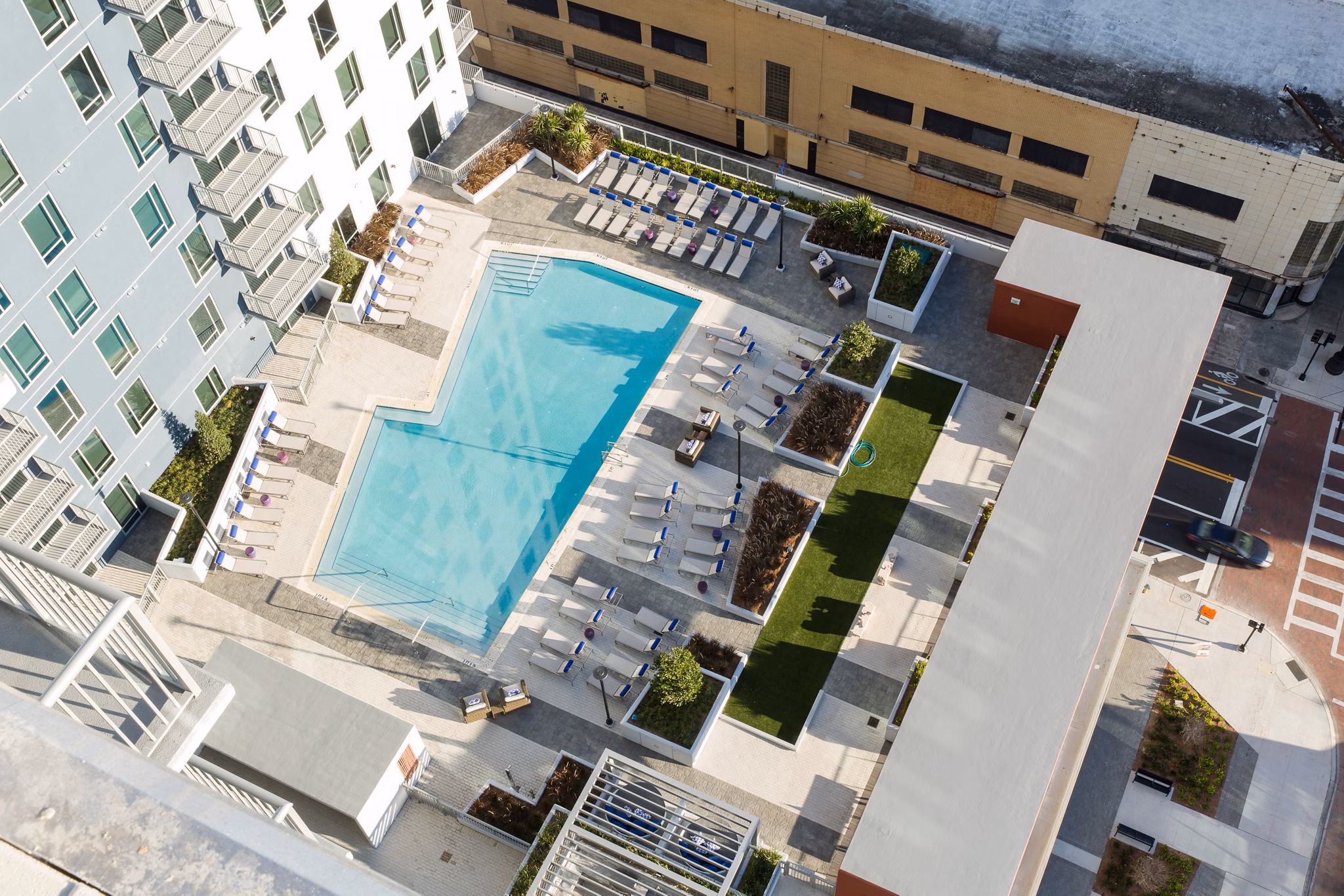 Modern infinity pool with cityscape views at Nine15 Apartments